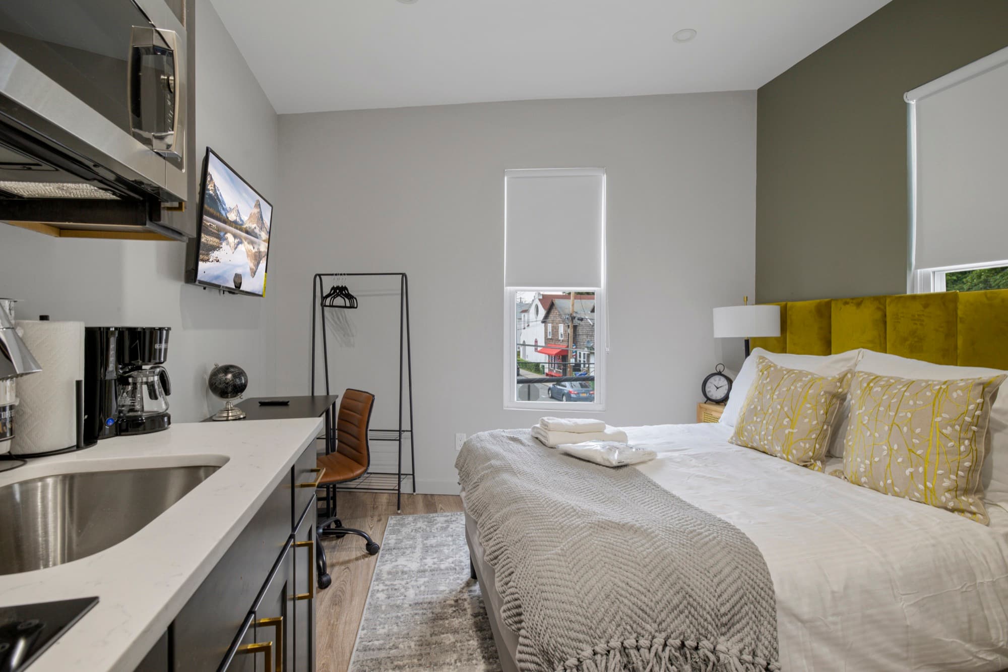 A standard suite: the kitchen counter and sink beside the bed
